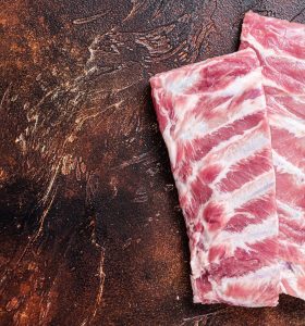 hema-farms-butchery-shop-rack-raw-pork-spare-ribs-butcher-table-dark-background-top-view